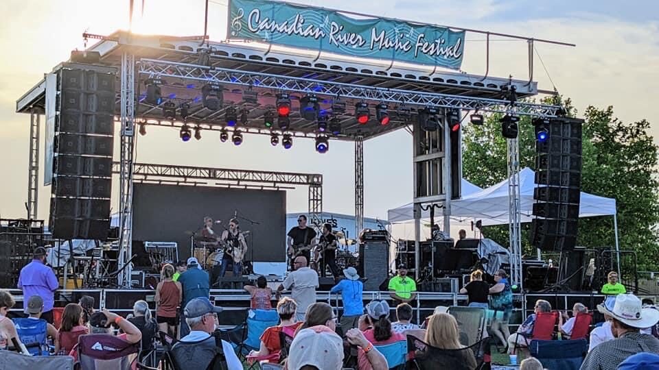 The CRMF main stage at golden hour with the crowd in lawn chairs